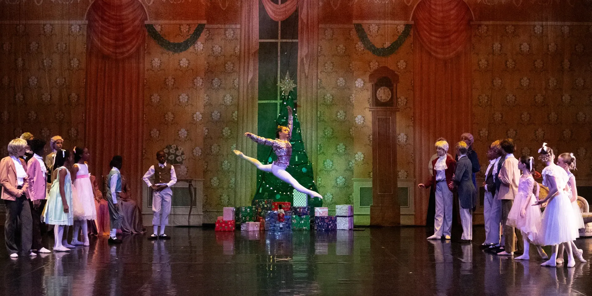 A group of dancers performing in the production of The Nutcracker ballet.